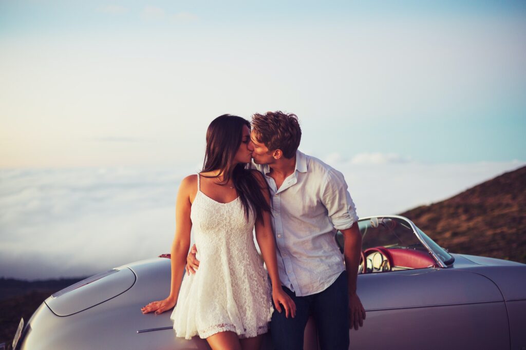Couple Kissing with Classic Vintage Sports Car